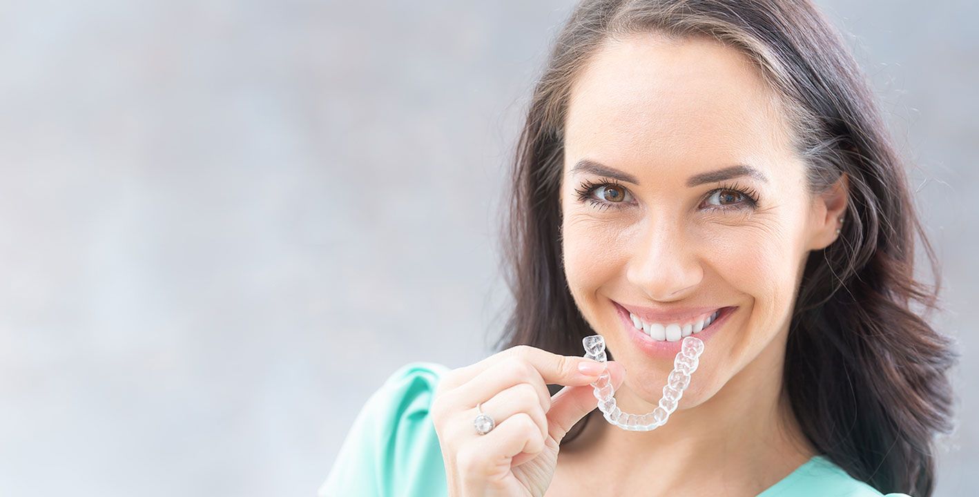 Woman smiling with a straight, healthy smile after Invisalign in Stouffville