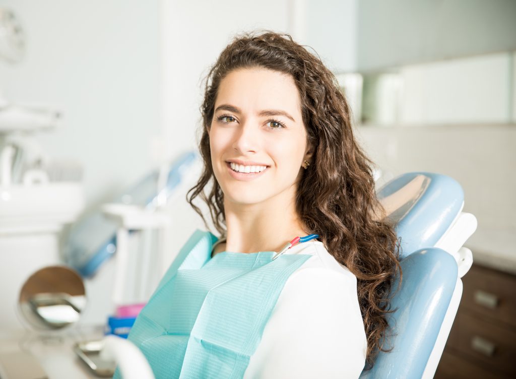 Smiling patient relaxing in a dental chair at a dental checkup